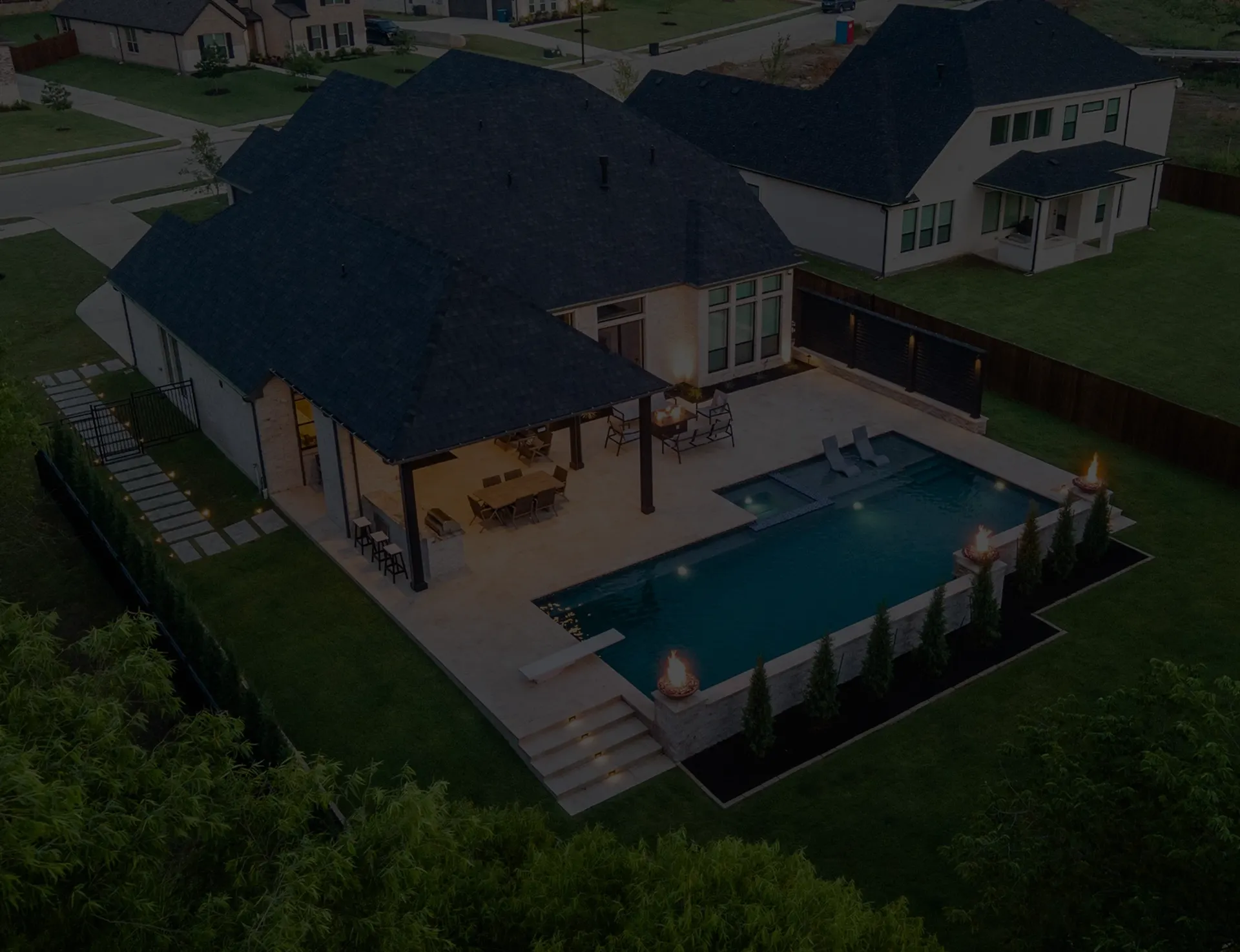 Aerial view of a rectangular pool, a covered patio and a brick home on a Middle Tennessee lot